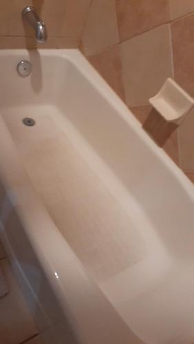 a white bath tub sitting in a bathroom at Disney 1 mile , Blue Heron 1 room 2 bath,amenities,6 guests, walk to restaurants, no fees at check in in Orlando