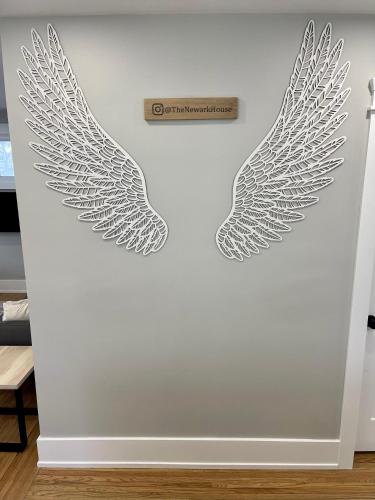 two wings stencils on a wall in a room at The Newark House in Niagara on the Lake