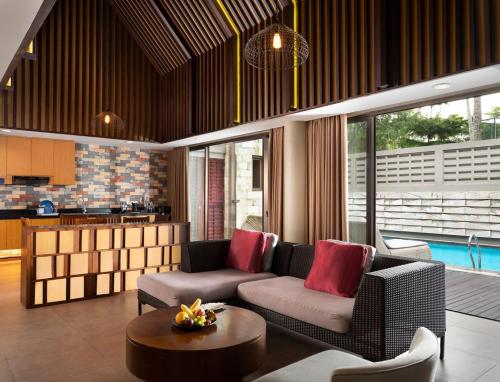 a living room with a couch and a table at Aston Sentul Lake Resort & Conference Center in Bogor