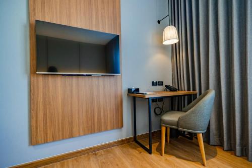 a room with a desk and a chair and a television at Best Western Chatuchak in Bangkok
