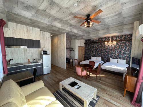 a living room with two beds and a table at WOLF PACK apartment 1002 in Osaka