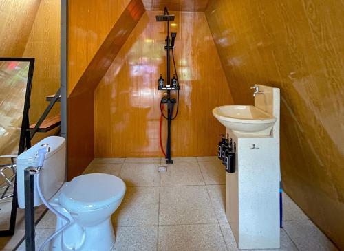 a bathroom with a toilet and a sink at Azana Essence Selo Boyolali in Boyolali