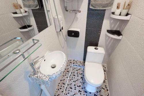 a small bathroom with a toilet and a sink at Wai fan Guest house in Hong Kong