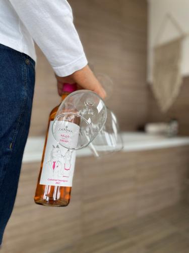 a person holding a wine glass in a kitchen at Csudahely - WonderPlace in Dunabogdány