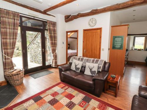 a living room with a couch and a table at The Hayloft in Keswick