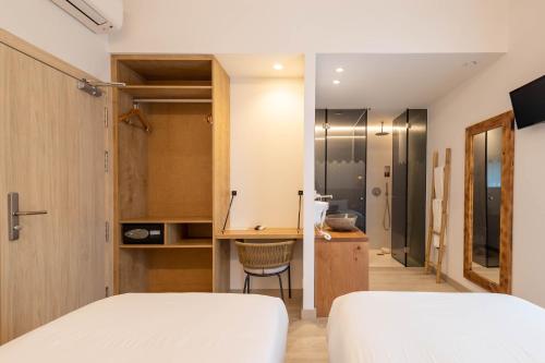 a bedroom with a bed and a desk and a chair at Play Hotel Ibiza - Adults Only in Ibiza Town