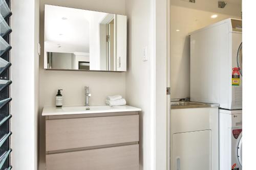 a small bathroom with a sink and a refrigerator at Retreat on Darling - Harbour Views 3 Bed in Sydney