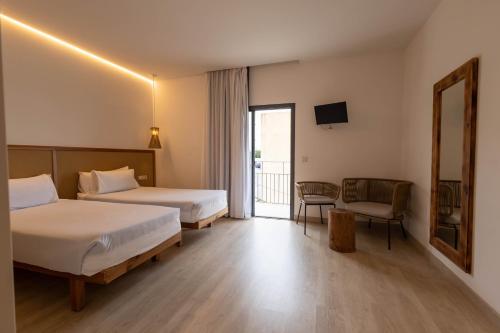 a hotel room with two beds and a balcony at Play Hotel Ibiza - Adults Only in Ibiza Town