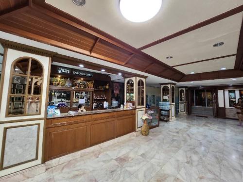 a restaurant with a bar in the middle of a room at White Rose​ Hotel​ II​ in Nong Prue