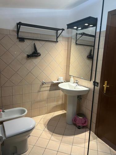 a bathroom with a toilet and a sink at Clock's House in Fiumicino