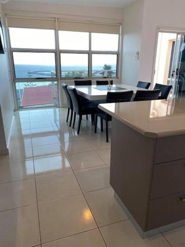 a kitchen with a table and chairs in a room at Views on Hughes in Port Moonta