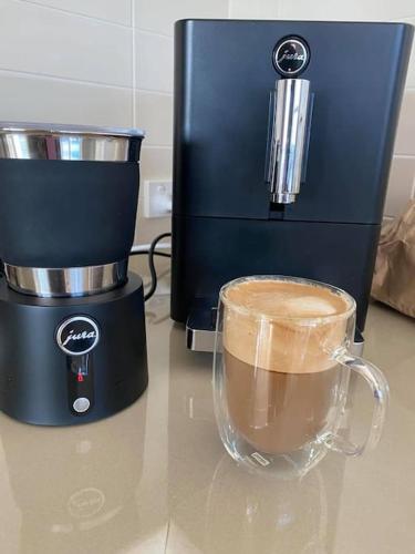 a coffee maker and a cup of coffee on a counter at Views on Hughes in Port Moonta