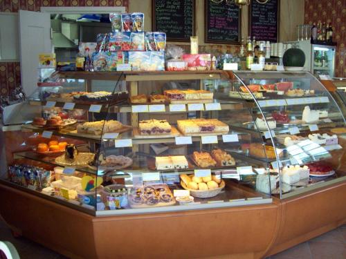 a bakery display case filled with lots of different pastries at Pension Villa Else in Heidenau