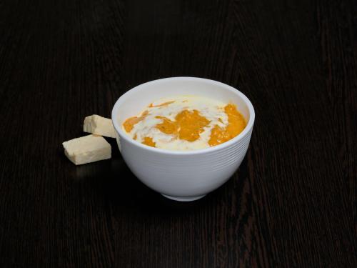 a bowl of cereal and a piece of cheese on a table at Zone Connect by The Park Port Blair in Port Blair