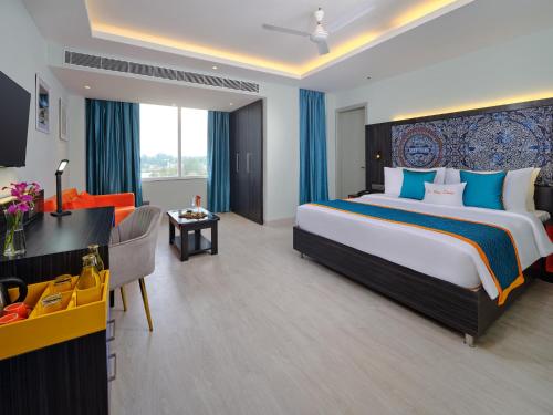 a hotel room with a large bed and a desk at Zone Connect by The Park Port Blair in Port Blair