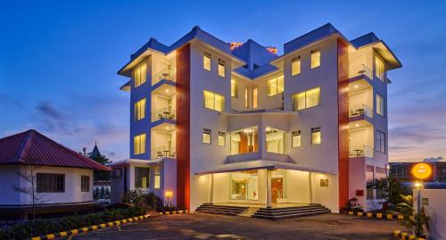 a large white building with its lights on at Zone Connect by The Park Port Blair in Port Blair
