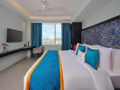 a hotel room with a large bed and a tv at Zone Connect by The Park Port Blair in Port Blair