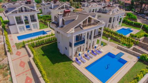an aerial view of a mansion with a swimming pool at Silver Sami Villa, Özel Havuzlu, Fethiye, in Fethiye