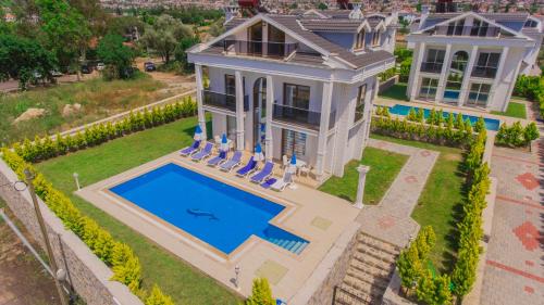 an aerial view of a house with a swimming pool at Silver Sami Villa, Özel Havuzlu, Fethiye, in Fethiye