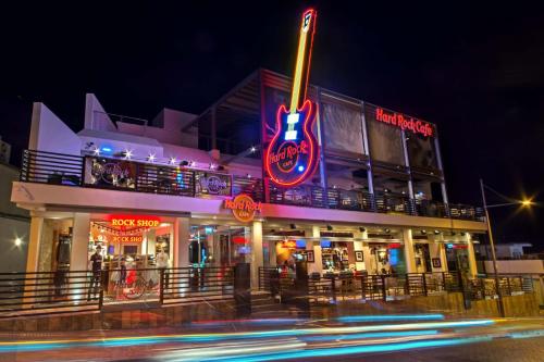 a building with a neon sign in front of it at Ayia Anna Apartment in Ayia Napa