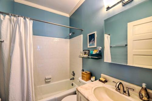 a bathroom with a tub and a toilet and a sink at Cozy, Updated Rocky Mt Home by City Lake Park in Rocky Mount