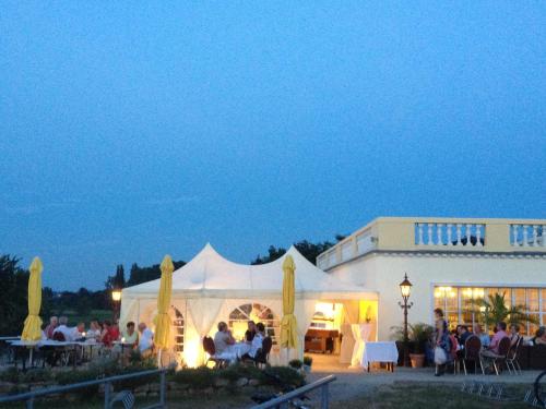 a group of people sitting inside of a white tent at Pension Villa Else in Heidenau
