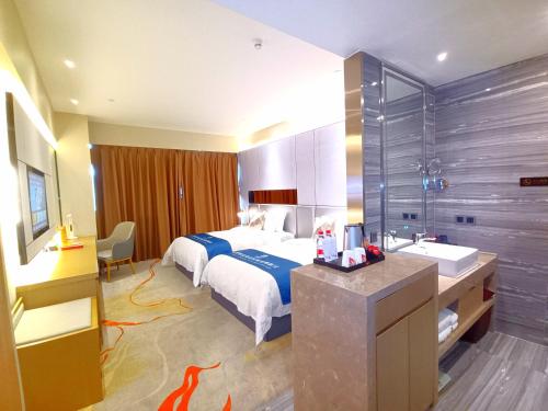 a hotel room with a bed and a sink at Qingyuan Argyle Hotel in Qingyuan