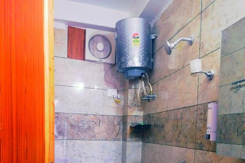 マナリにあるMountain Hills Home Stay Manaliのバスルーム(シャワー、壁にタンク付)