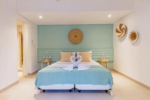 a bedroom with a bed with a bow on it at Villa Senan in Seminyak