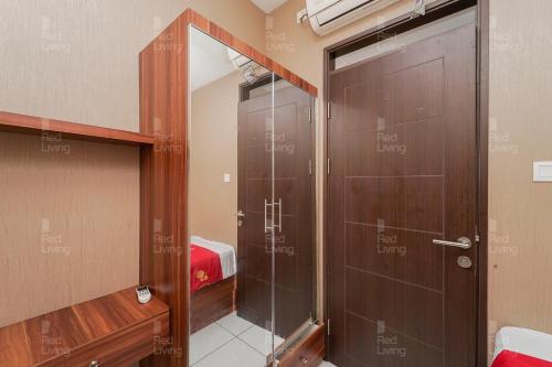 a shower in a room with a glass door at RedLiving Apartemen Mekarwangi Square - Agus 3 Tower A in Bandung