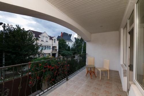 a balcony with two chairs and a table on it at ezio in Chişinău
