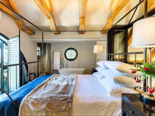 a bedroom with a large bed and a bathroom at Devon Castle Forest Lodge in Stellenbosch