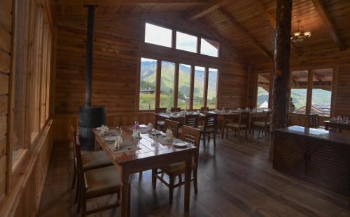 a dining room with tables and chairs and windows at Tenzinling Luxury Villa Tents in Paro