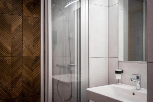 a bathroom with a shower and a sink at Espak Hostel in Tallinn