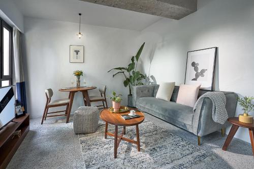a living room with a couch and a table at basePLUS-Shanghai BINJIANG Serviced Apartment in Shanghai