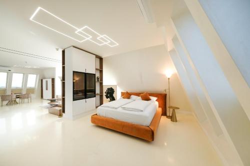 a bedroom with a bed and a living room at NED Hotel in Graz