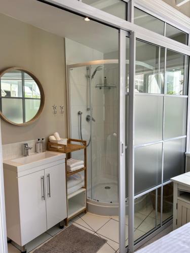 a bathroom with a shower and a sink at One Oak Guest House in Somerset West
