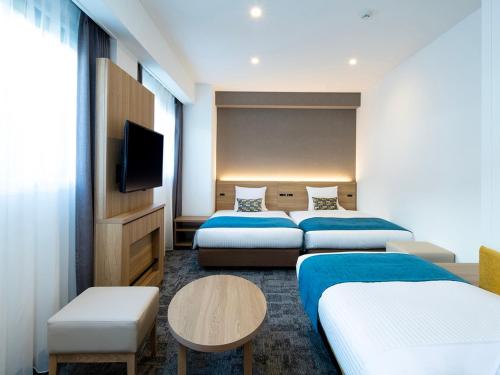 Postel nebo postele na pokoji v ubytování FLEXSTAY INN Shinurayasu