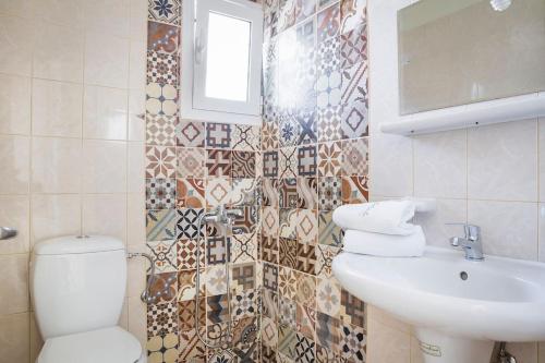 a bathroom with a toilet and a sink at Cactus Apartment in Kefallonia