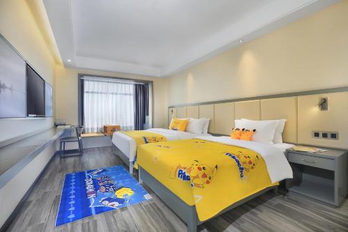 a hotel room with two beds and a flat screen tv at Wing Hotel Guilin - Central Square in Guilin
