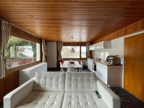 a living room with a white couch in a kitchen at Lovely Apt Chalet Courchevel 1650 in Courchevel