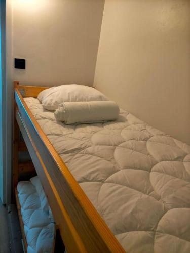 a bunk bed with a pillow on top of it at Crest Voland, Le Cernix studio de standing rénové in Cohennoz