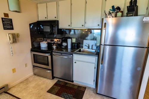 a kitchen with a stainless steel refrigerator and a sink at ML332 1BR1BA Slope View WiFi Parking Village in Snowshoe
