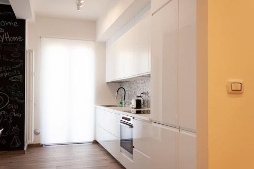 a kitchen with white cabinets and a stove at Lucky Home Near Train Station and City center in Verona