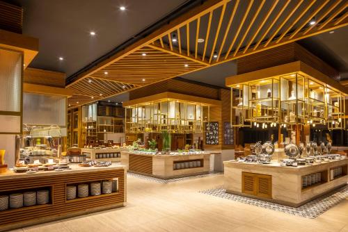 a restaurant with counters and tables in a room at Melia Vinpearl Thanh Hoa in Thanh Hóa