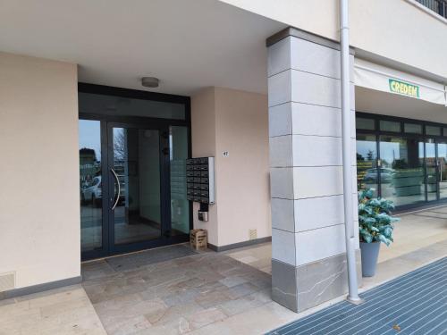 a building with a sign in front of it at Center Aviano Comfort Suite FREE PARKING WIFI in Aviano