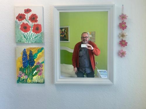 a man taking a picture of himself in a mirror at Haus am Kurpark in Schömberg