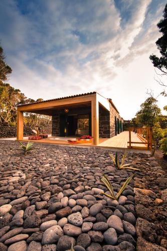 a house with a stone walkway in front of it at Pocinhobay in Madalena