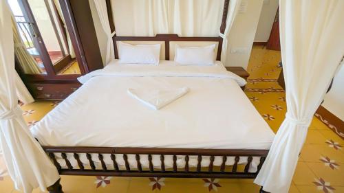 a bedroom with two beds with white sheets at The Royale Ridge in Kotagiri