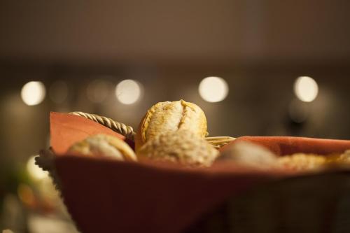 a basket of food with bread in it at Hotel Kiez Pension Berlin in Berlin